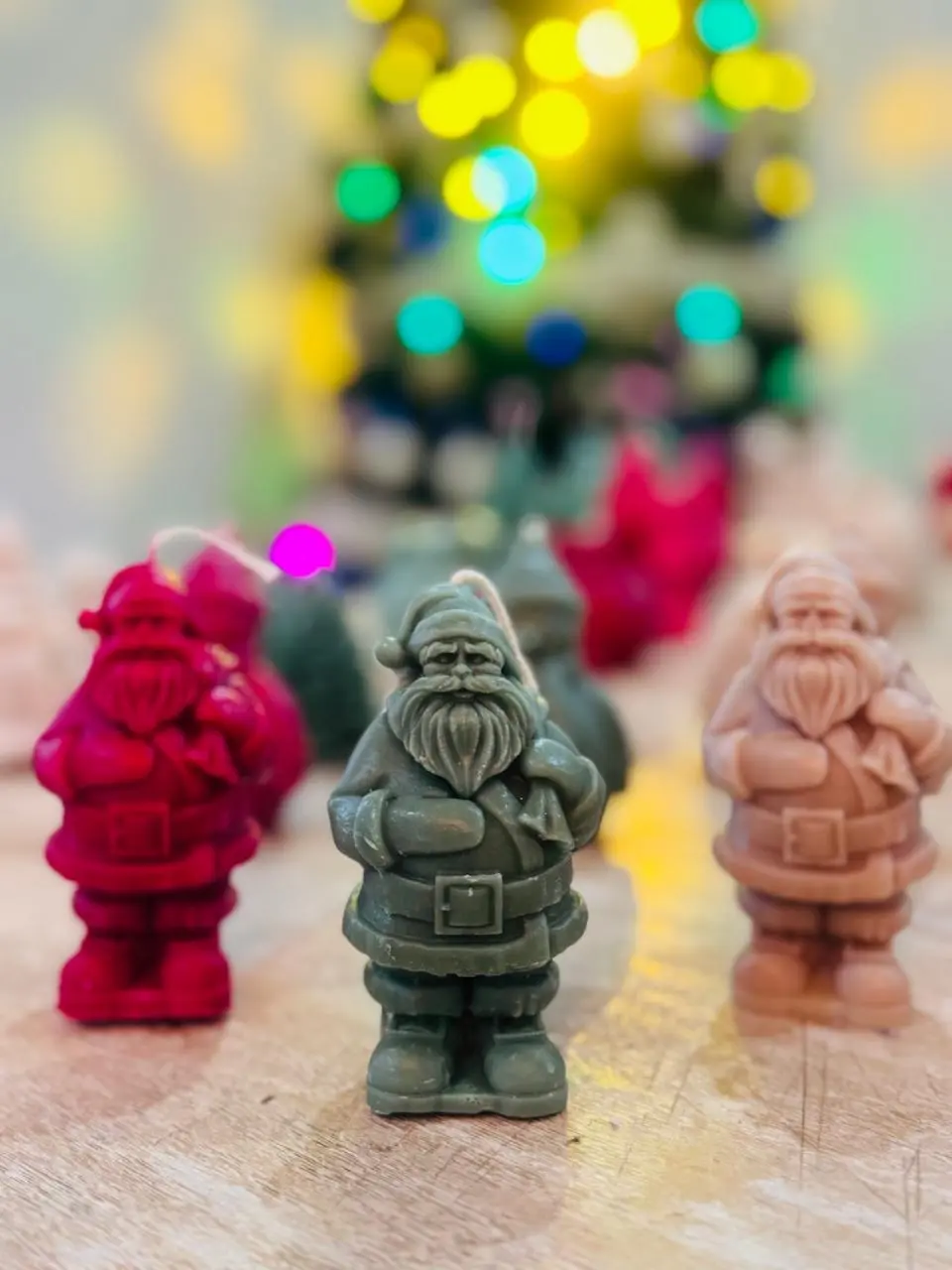 Red, green and nude santa claus candles.