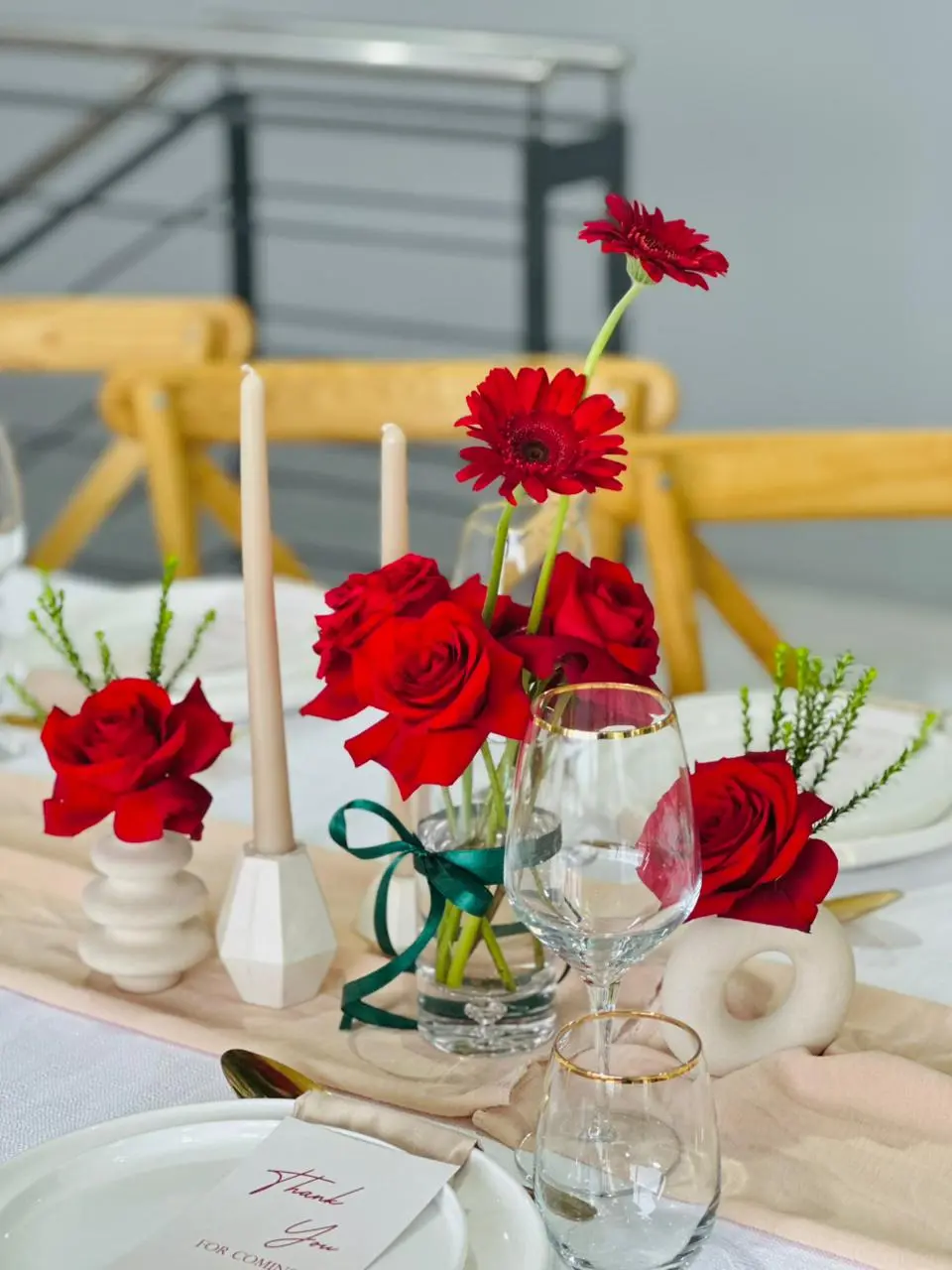 Wedding table decor with a wine glass, red roses and 